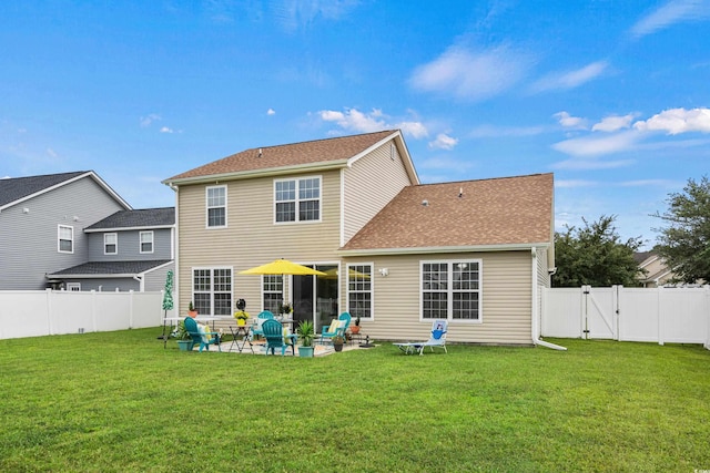 rear view of house with a patio area and a yard