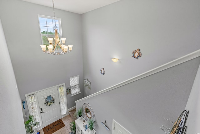 foyer with light tile patterned floors and a chandelier