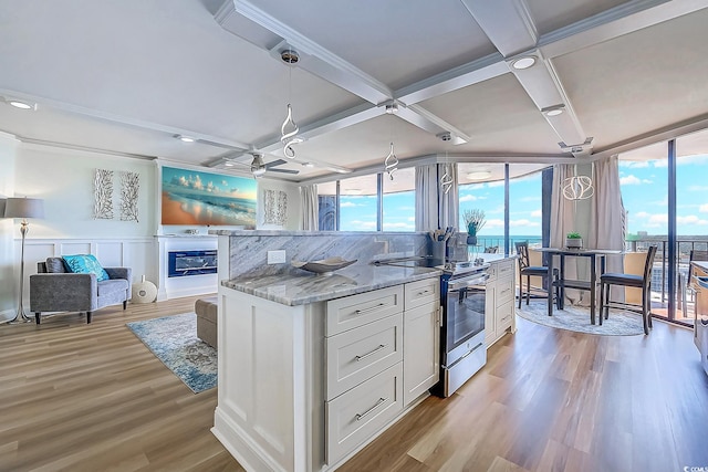 9650 Shore Dr Unit 902, Myrtle Beach, SC 29572 - kitchen with white cabinets, electric range, light wood-type flooring, open floor plan, and coffered ceiling