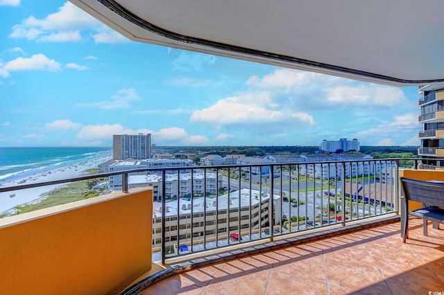 balcony featuring a beach view and a water view