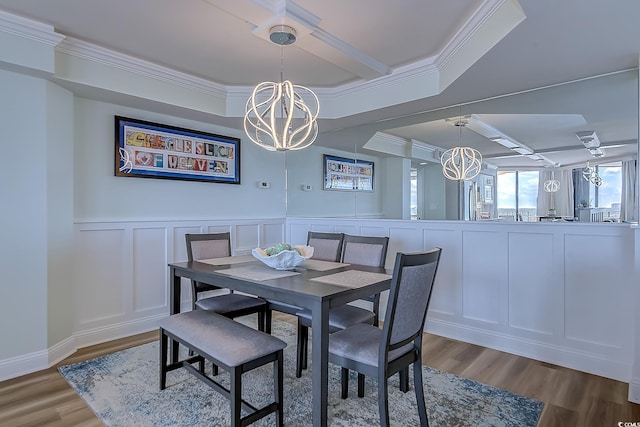 9650 Shore Dr Unit 902, Myrtle Beach, SC 29572 - dining room featuring a decorative wall, wood finished floors, a chandelier, a wainscoted wall, and ornamental molding