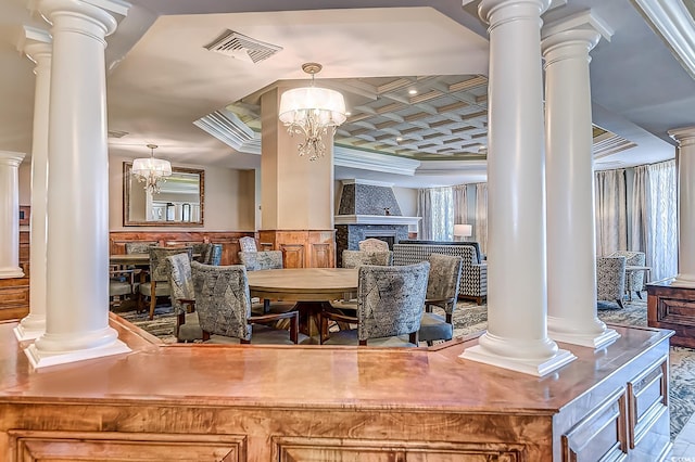 dining space with decorative columns and a chandelier