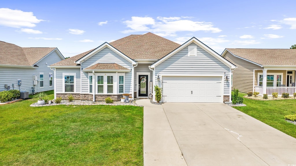 ranch-style house with central AC unit, a front yard, and a garage