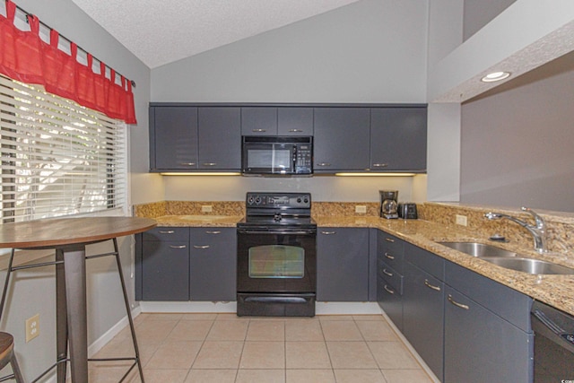 kitchen with light tile patterned floors, light stone countertops, sink, lofted ceiling, and black appliances