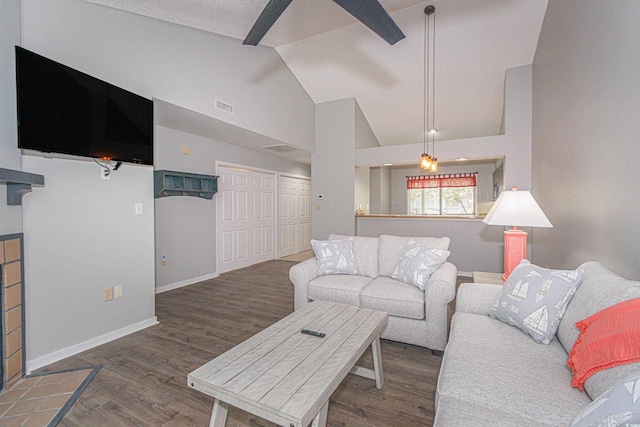 living room featuring dark hardwood / wood-style floors and high vaulted ceiling