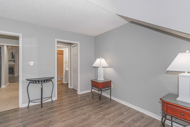 interior space featuring dark hardwood / wood-style flooring and a textured ceiling