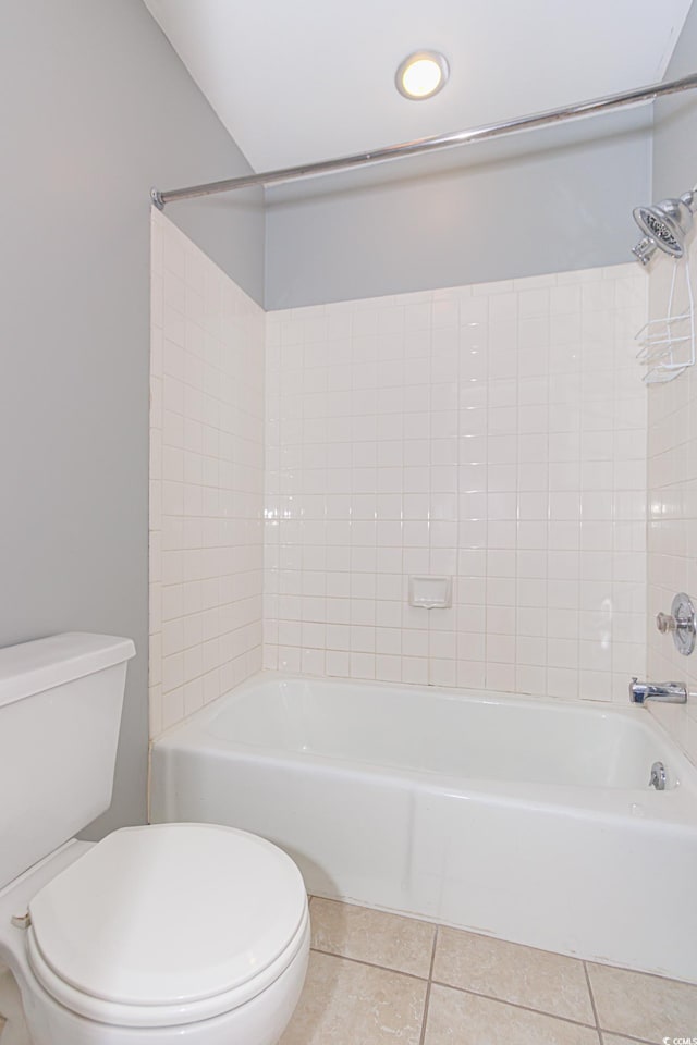 bathroom with toilet, tile patterned flooring, and bathing tub / shower combination