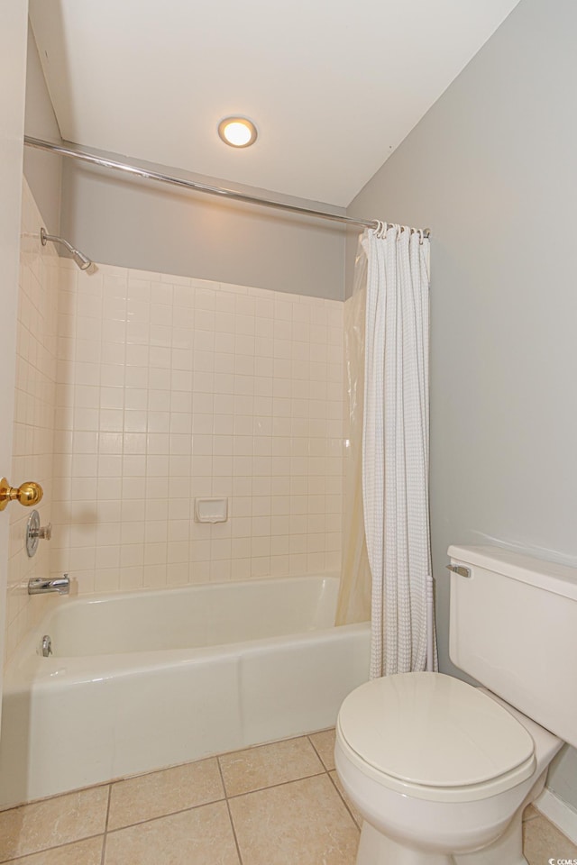 bathroom with toilet, shower / tub combo with curtain, and tile patterned floors