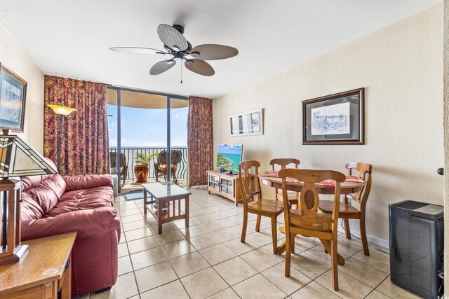 2500 N Ocean Blvd Unit 605, Myrtle Beach, SC 29577 - living area with a ceiling fan, floor to ceiling windows, baseboards, light tile patterned flooring, and a textured wall