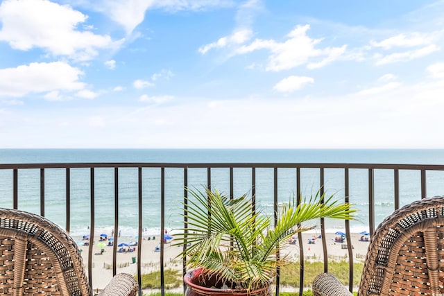 balcony with a beach view and a water view