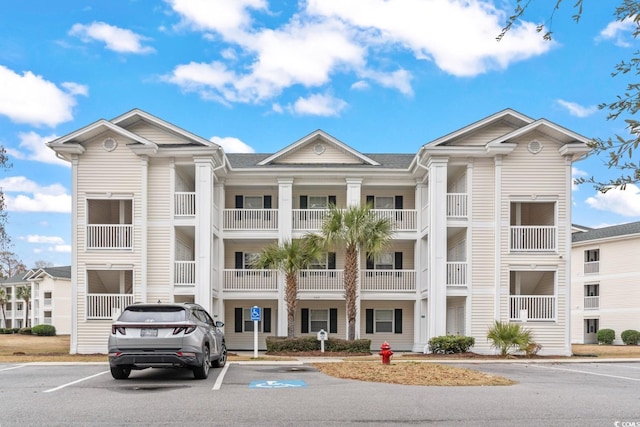 view of property featuring uncovered parking