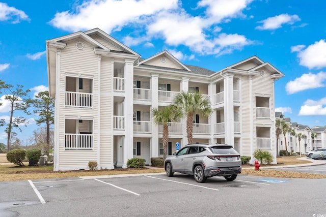 view of building exterior with uncovered parking