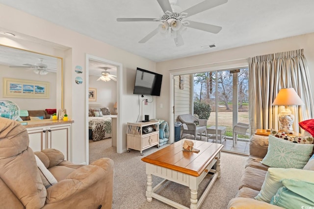 carpeted living room featuring ceiling fan