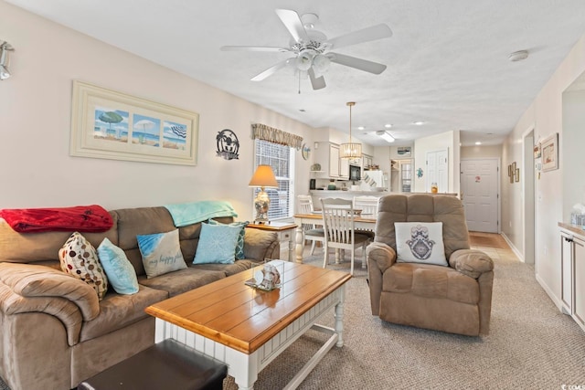 carpeted living room featuring ceiling fan