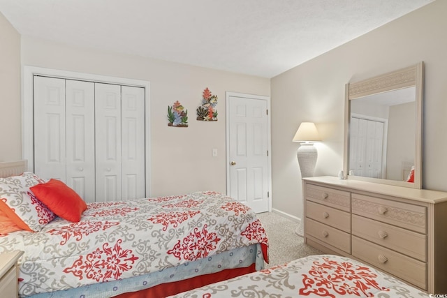 bedroom with a closet and light carpet