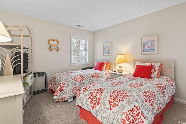 carpeted bedroom featuring visible vents