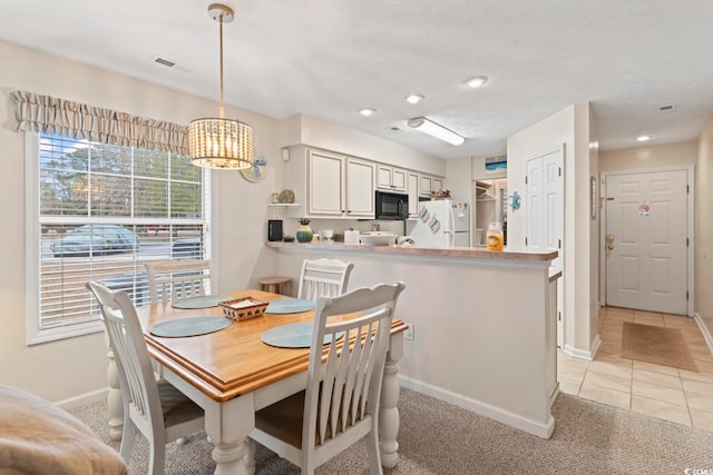 tiled dining room featuring a chandelier