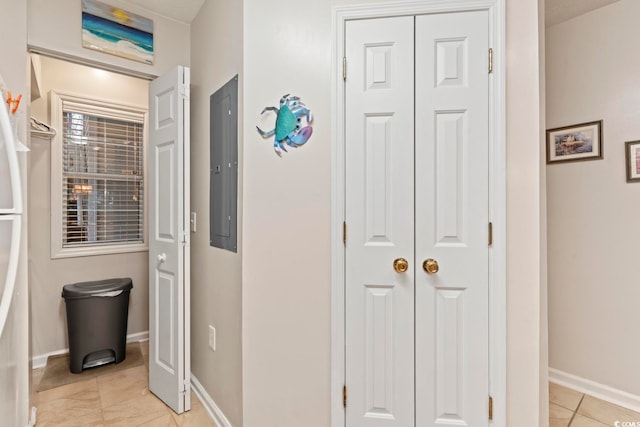 corridor featuring electric panel and light tile patterned floors