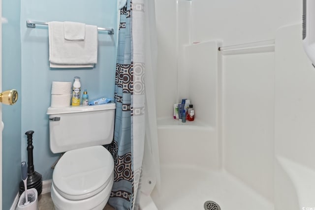 full bathroom with toilet and a shower stall