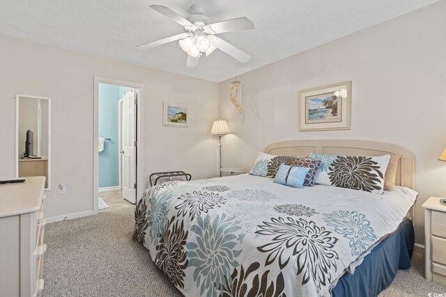 bedroom featuring ensuite bath, ceiling fan, and light colored carpet