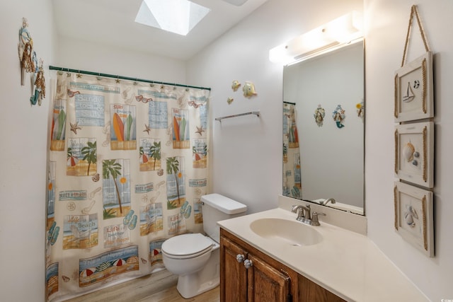 bathroom featuring hardwood / wood-style flooring, a shower with shower curtain, a skylight, vanity, and toilet