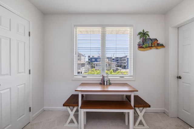 dining area featuring light colored carpet