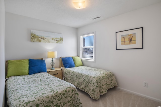 carpeted bedroom featuring a textured ceiling