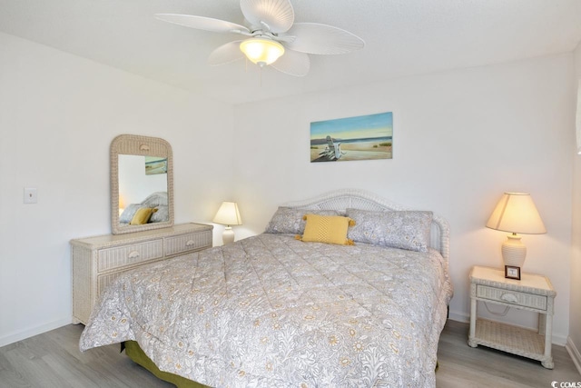 bedroom with hardwood / wood-style floors and ceiling fan