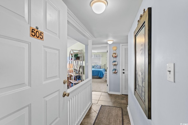 corridor featuring dark tile patterned flooring