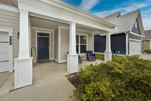 entrance to property with a garage and covered porch