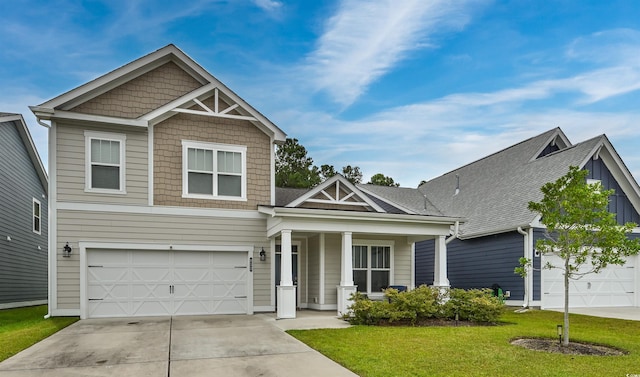 craftsman-style house featuring a garage and a front lawn