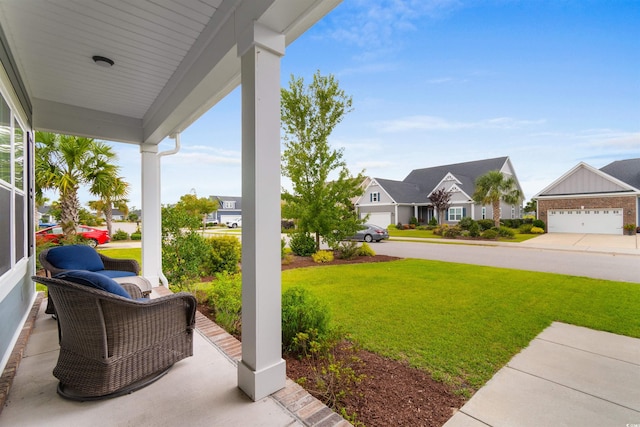 view of yard with covered porch and a garage