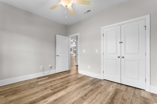 unfurnished bedroom featuring a closet, light hardwood / wood-style floors, and ceiling fan