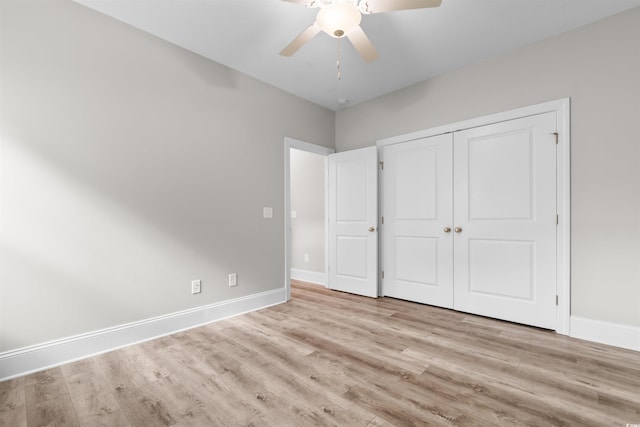 unfurnished bedroom featuring a closet, light hardwood / wood-style floors, and ceiling fan