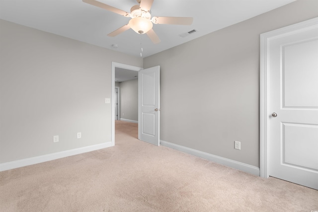 empty room with ceiling fan and light colored carpet