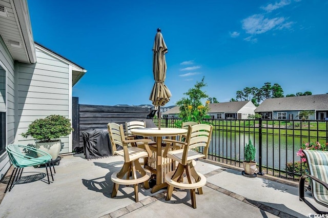 view of patio with a water view