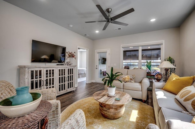 living room with ceiling fan and dark hardwood / wood-style flooring