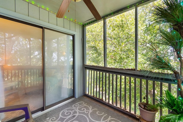 unfurnished sunroom featuring ceiling fan