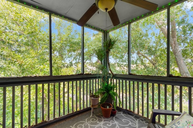 unfurnished sunroom featuring ceiling fan