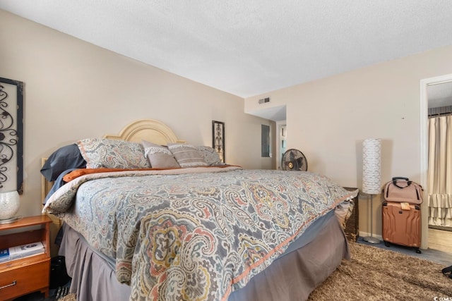 bedroom featuring carpet floors and a textured ceiling