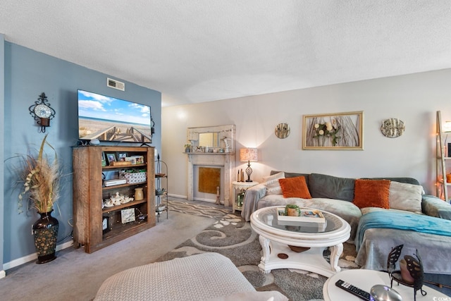 carpeted living room featuring a textured ceiling