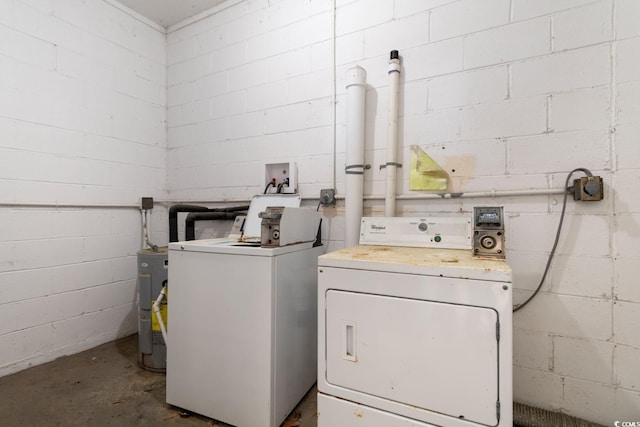 washroom with electric water heater and washing machine and clothes dryer