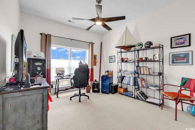 carpeted office featuring visible vents and ceiling fan