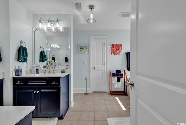 bathroom with tile patterned floors, visible vents, vanity, and baseboards