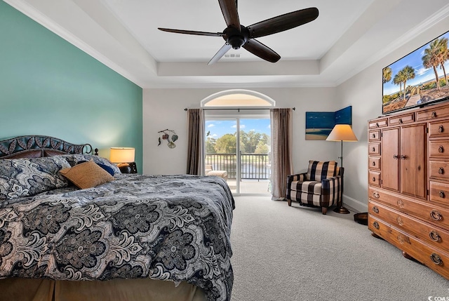 carpeted bedroom with ceiling fan, a tray ceiling, baseboards, and access to exterior