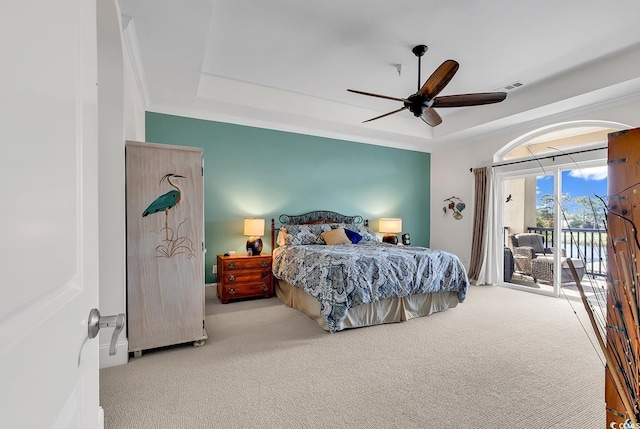 bedroom featuring access to exterior, visible vents, carpet, and a tray ceiling