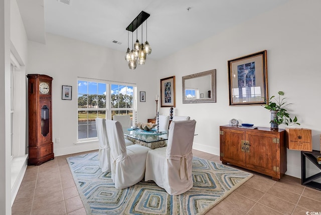 dining room with light tile patterned floors, visible vents, and baseboards