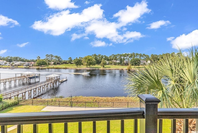 view of dock featuring fence and a water view