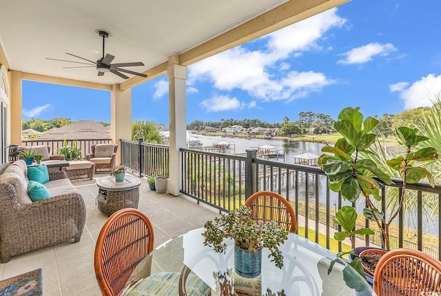 balcony with a water view, ceiling fan, and an outdoor hangout area