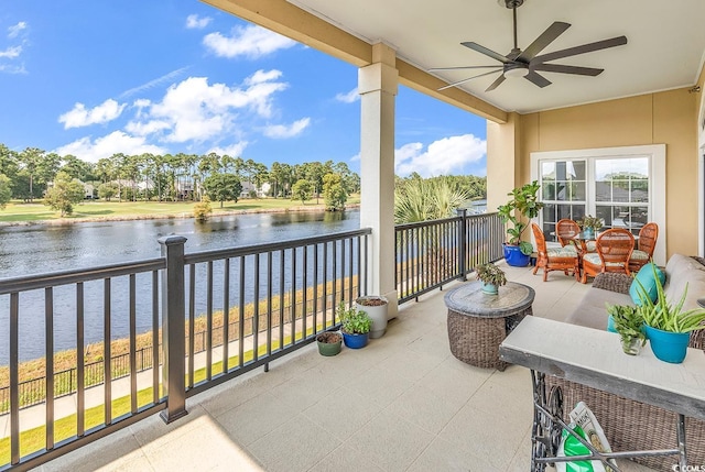 balcony with a ceiling fan and a water view